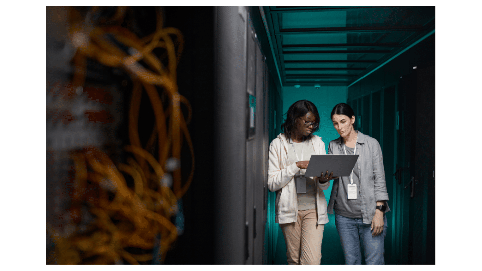 Two people troubleshoot during the deployment of a Storage Area Network (SAN).